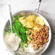 cheese ravioli with asparagus in a large silver pan