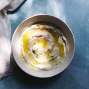 avocado dip in a bowl on a blue counter