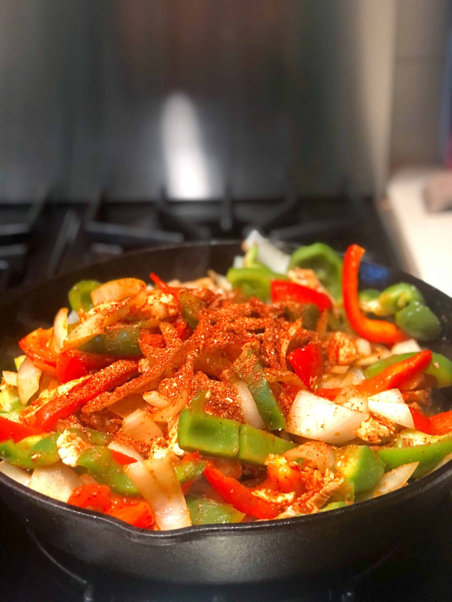 Fajitas with seasoning in pan.