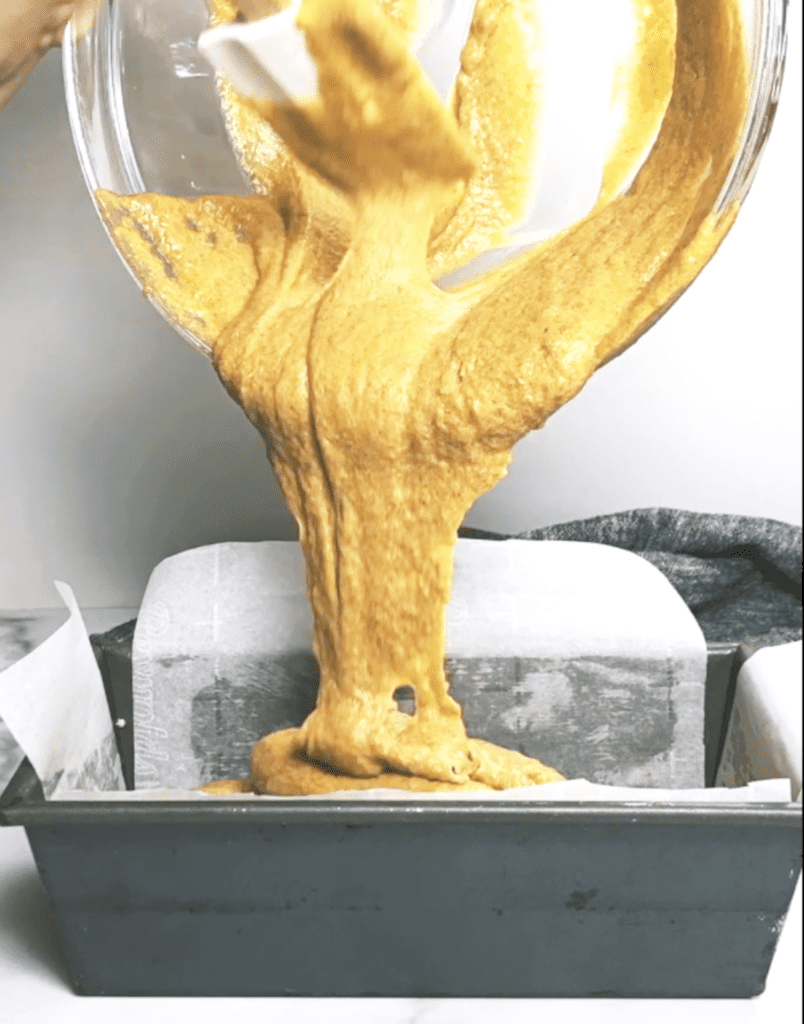 pumpkin cake being poured into bowl