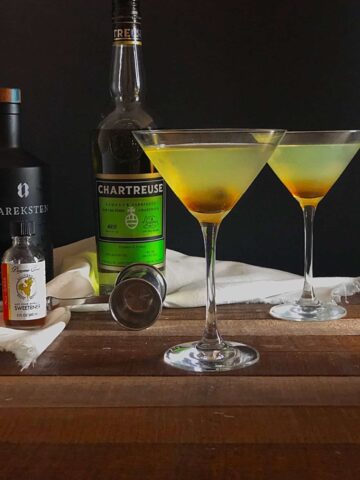 Chartreuse cocktail on wood table.