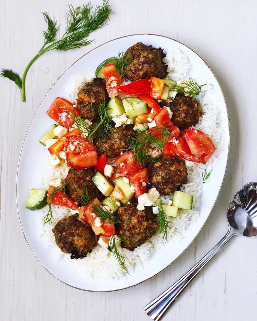 Kofta meatballs on a plate with rice and tomatoes