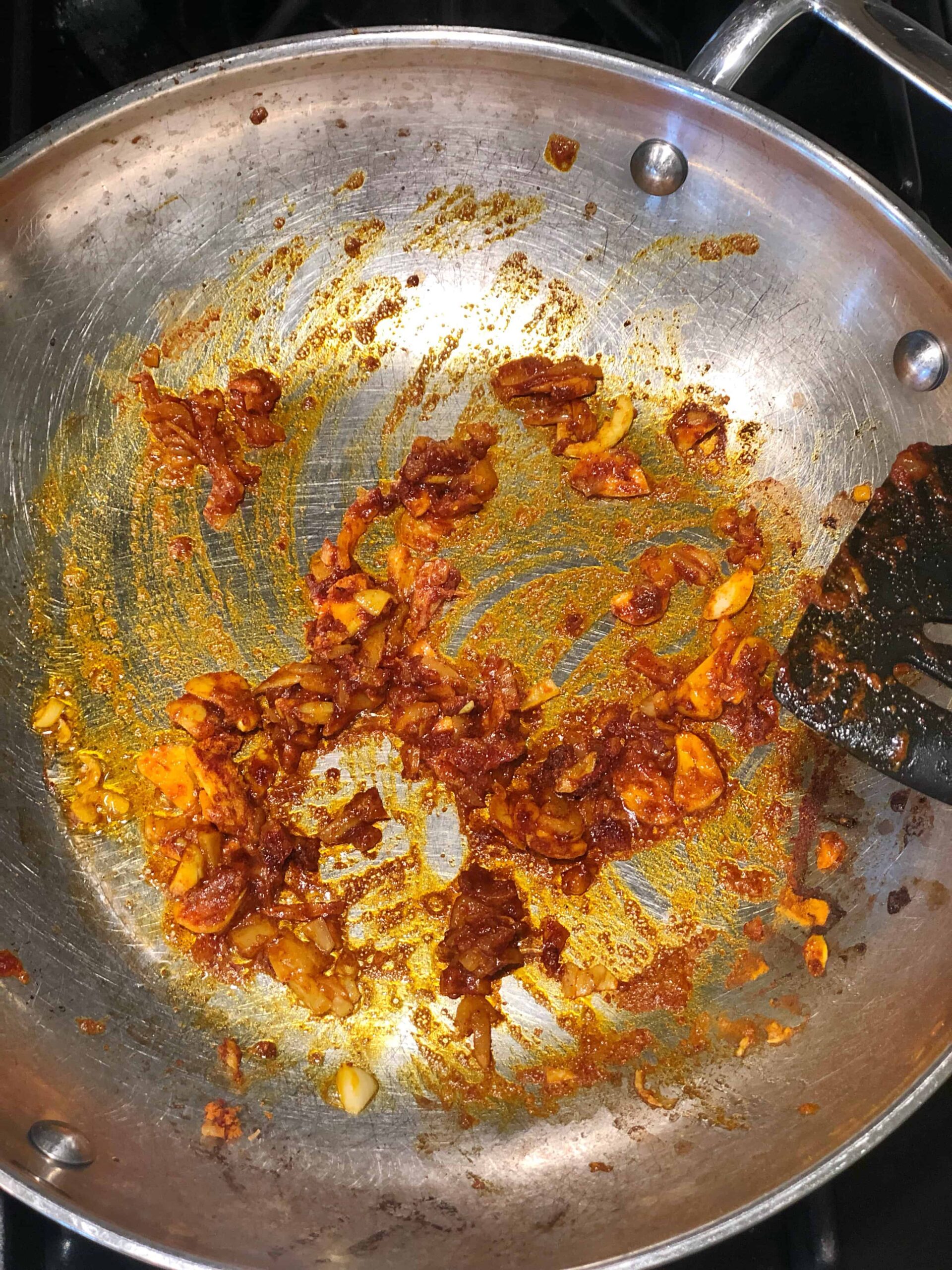 turmeric spices cooking in a saute pan.