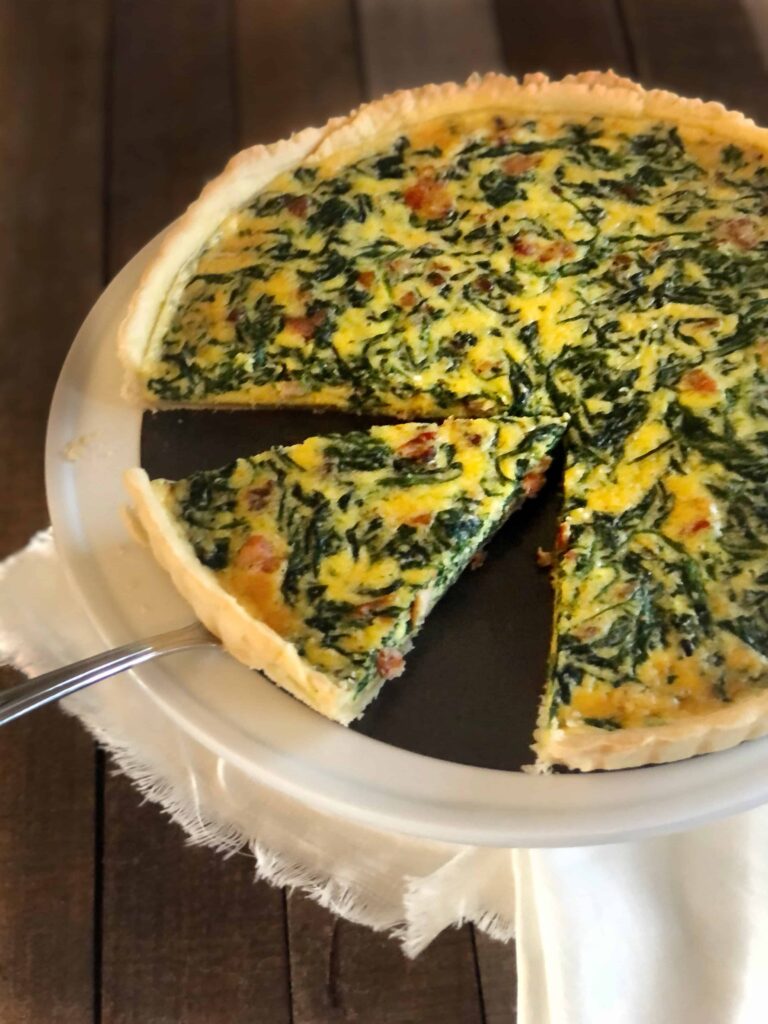 Spinach and pancetta quiche being served.