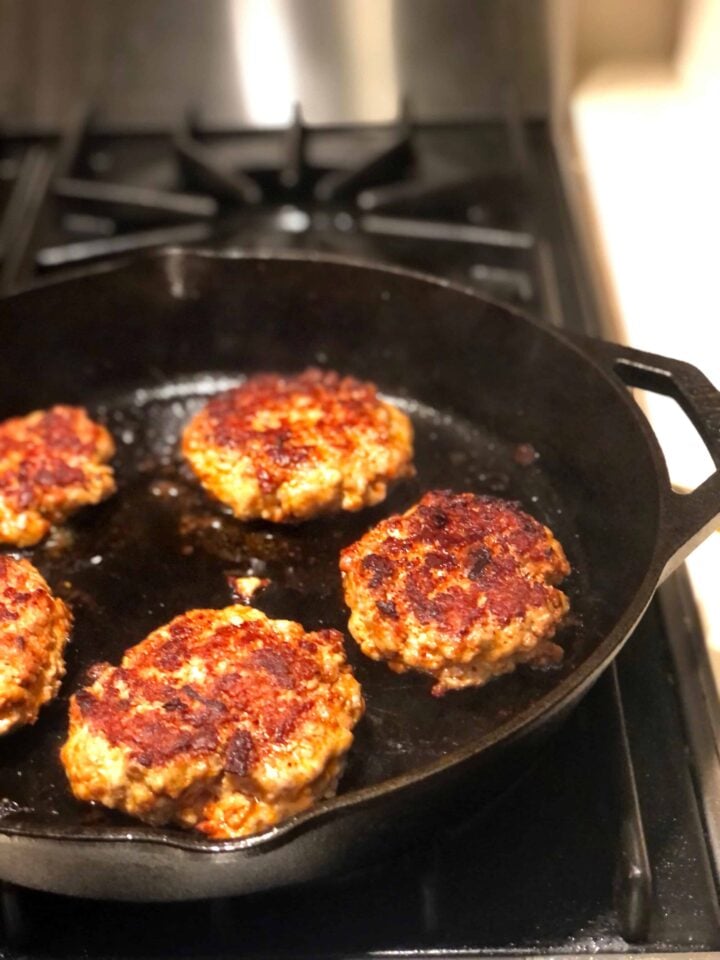 burgers cooking in cast iron