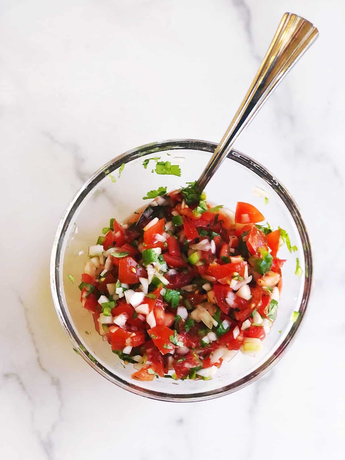 mixing the homemade pico de gallo