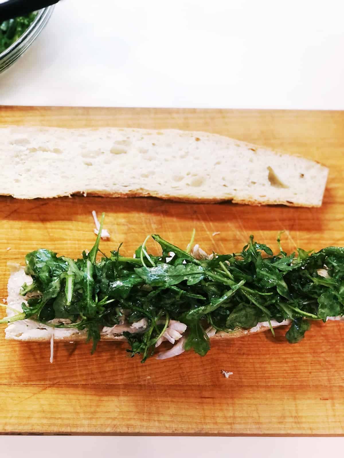 arugula on top of baguette