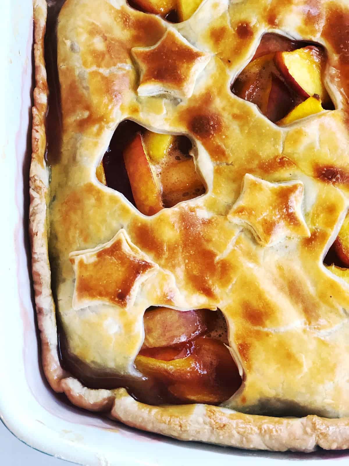closeup of the whole peach cobbler in the pan 
