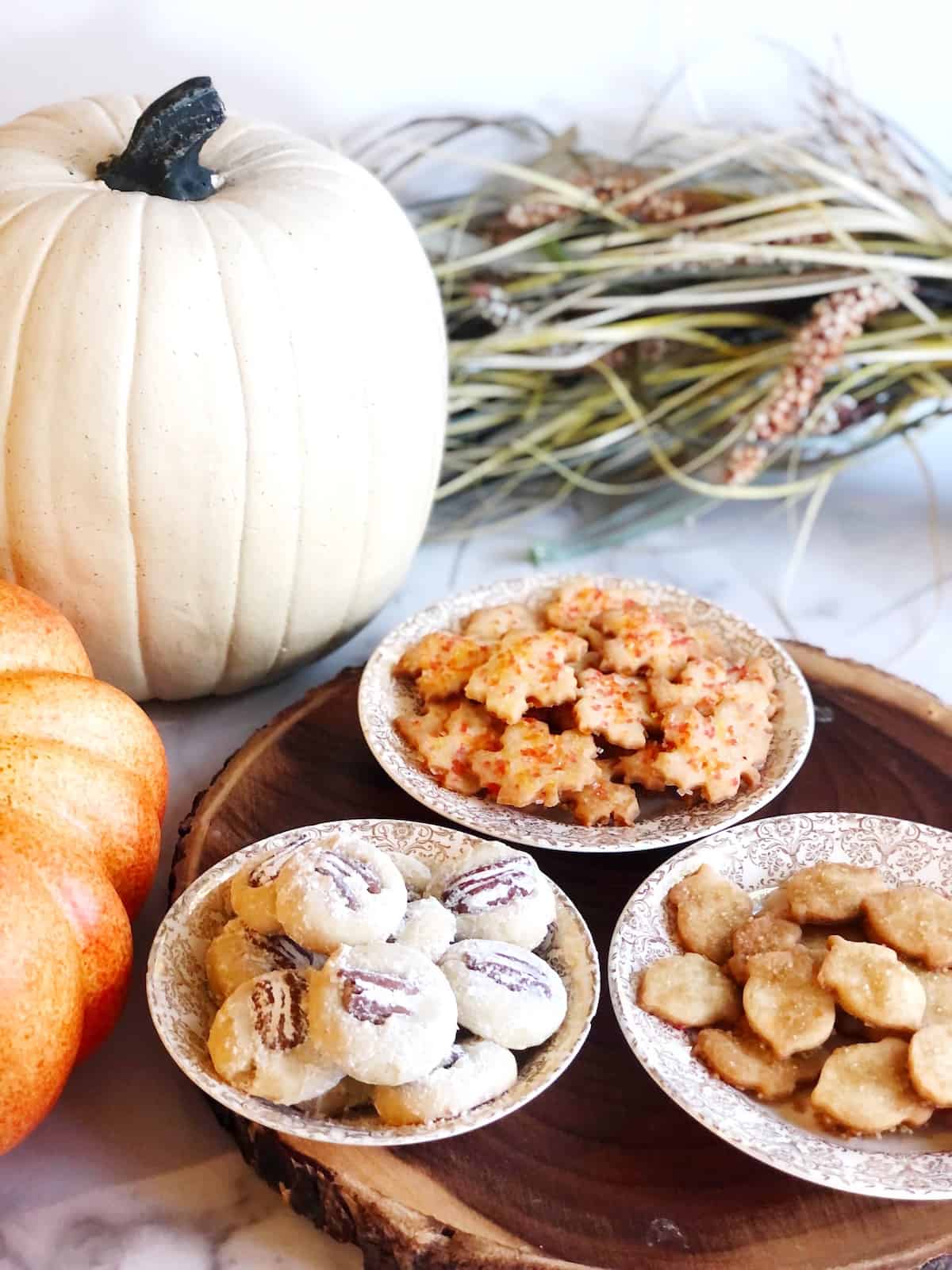 Fall cookies with sprinkles and fall cookies with pecans in bowls on the table