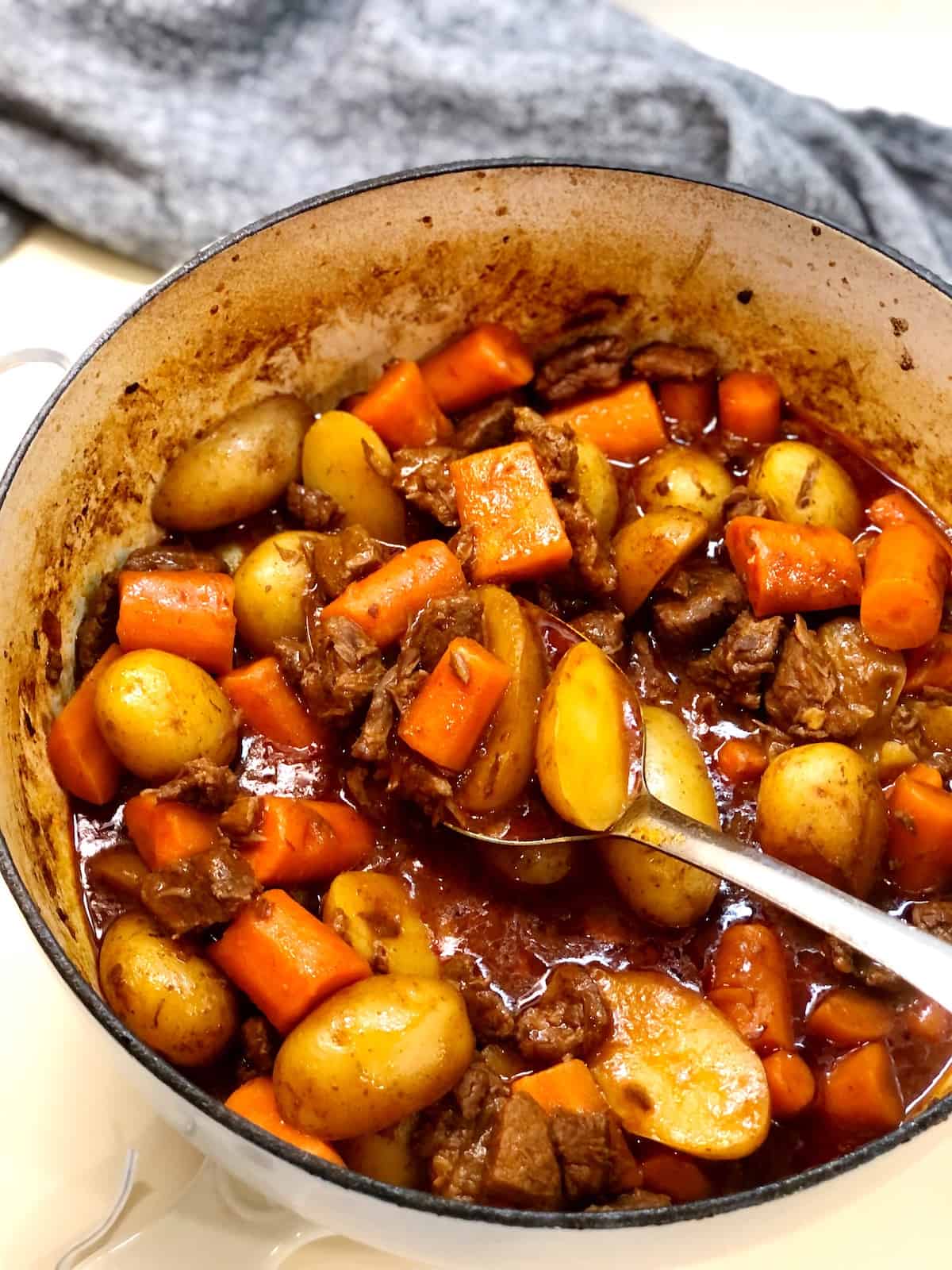 finished dutch oven beef stew with spoon