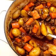 old fashioned beef stew in pot with spoon in a closeup view