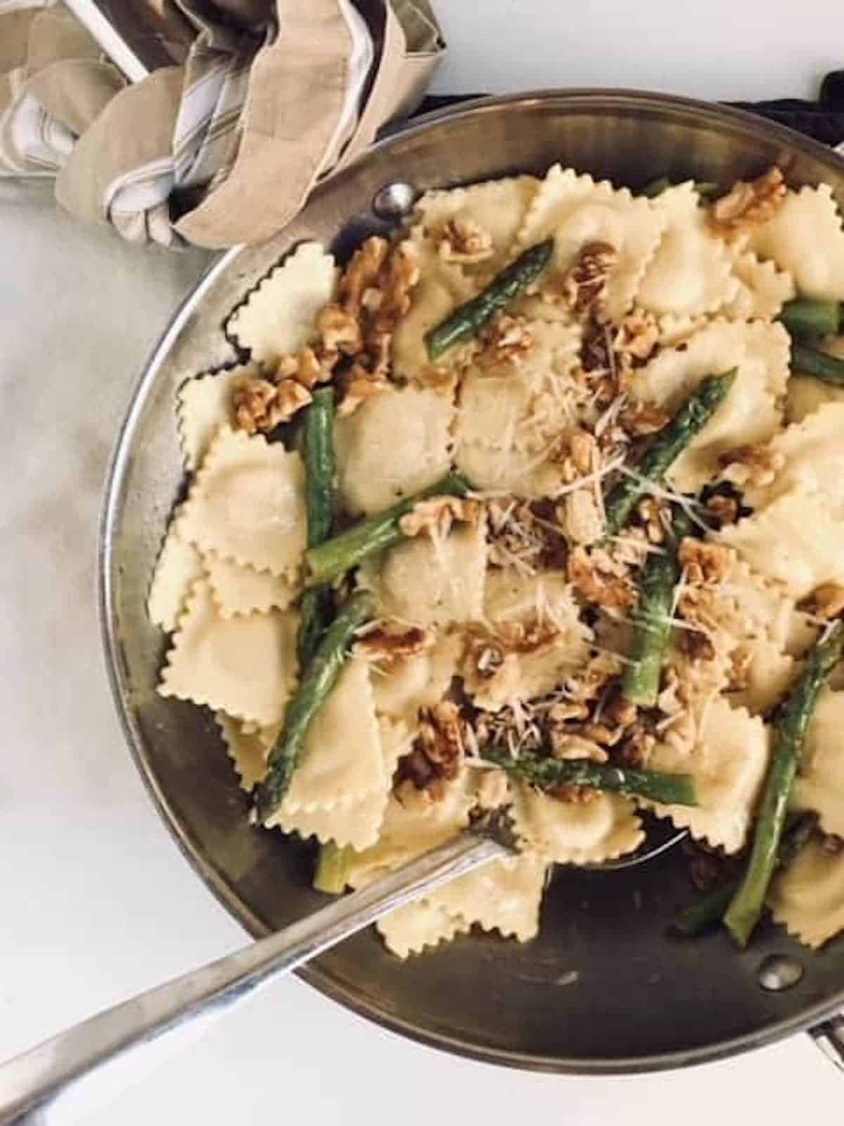 ravioli in brown butter sauce tossed together in pan