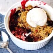 berry-crisp in bowl with ice cream on top