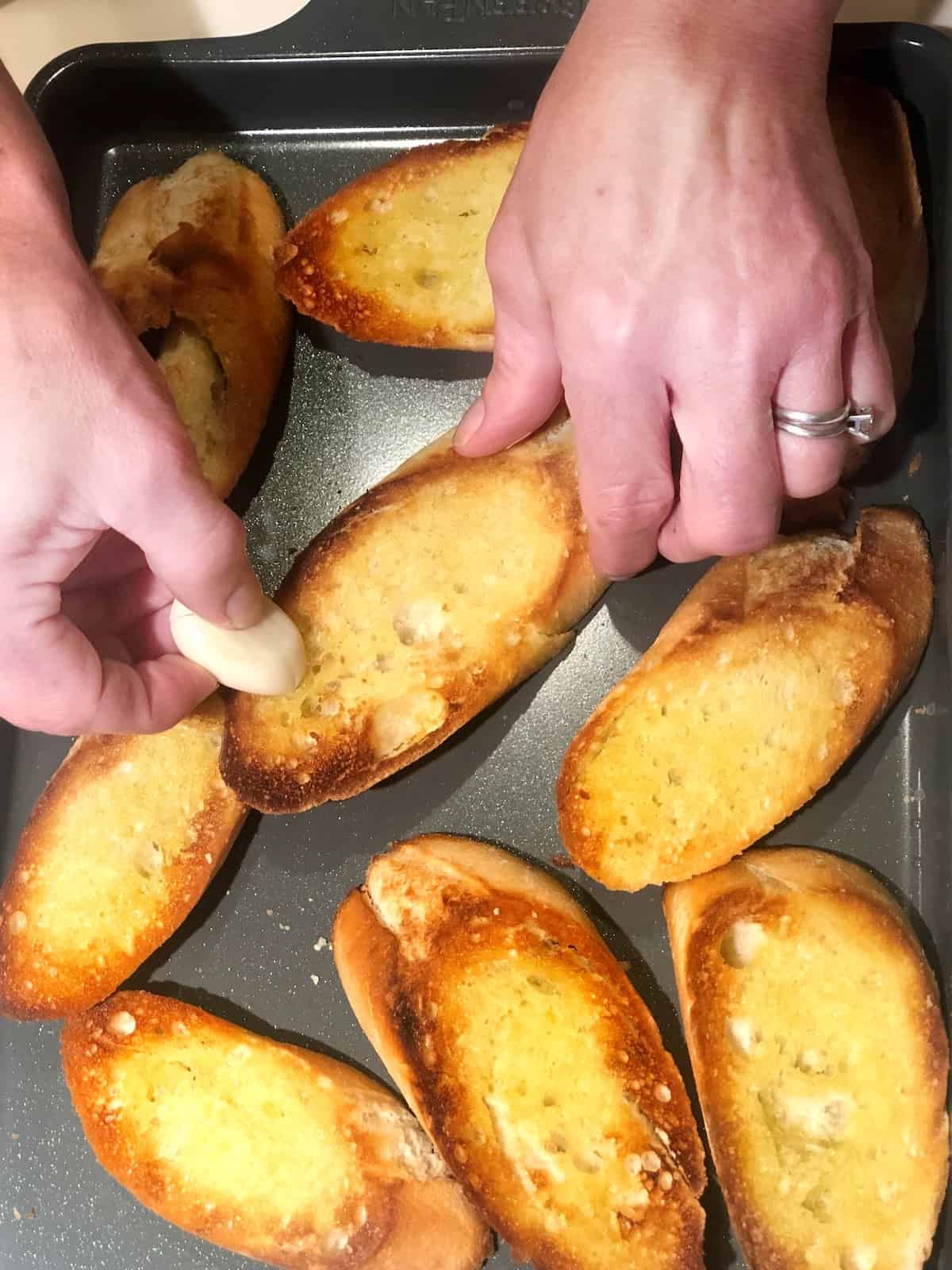 rubbing garlic on bread