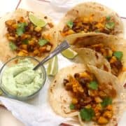 chorizo tacos on plate with avocado