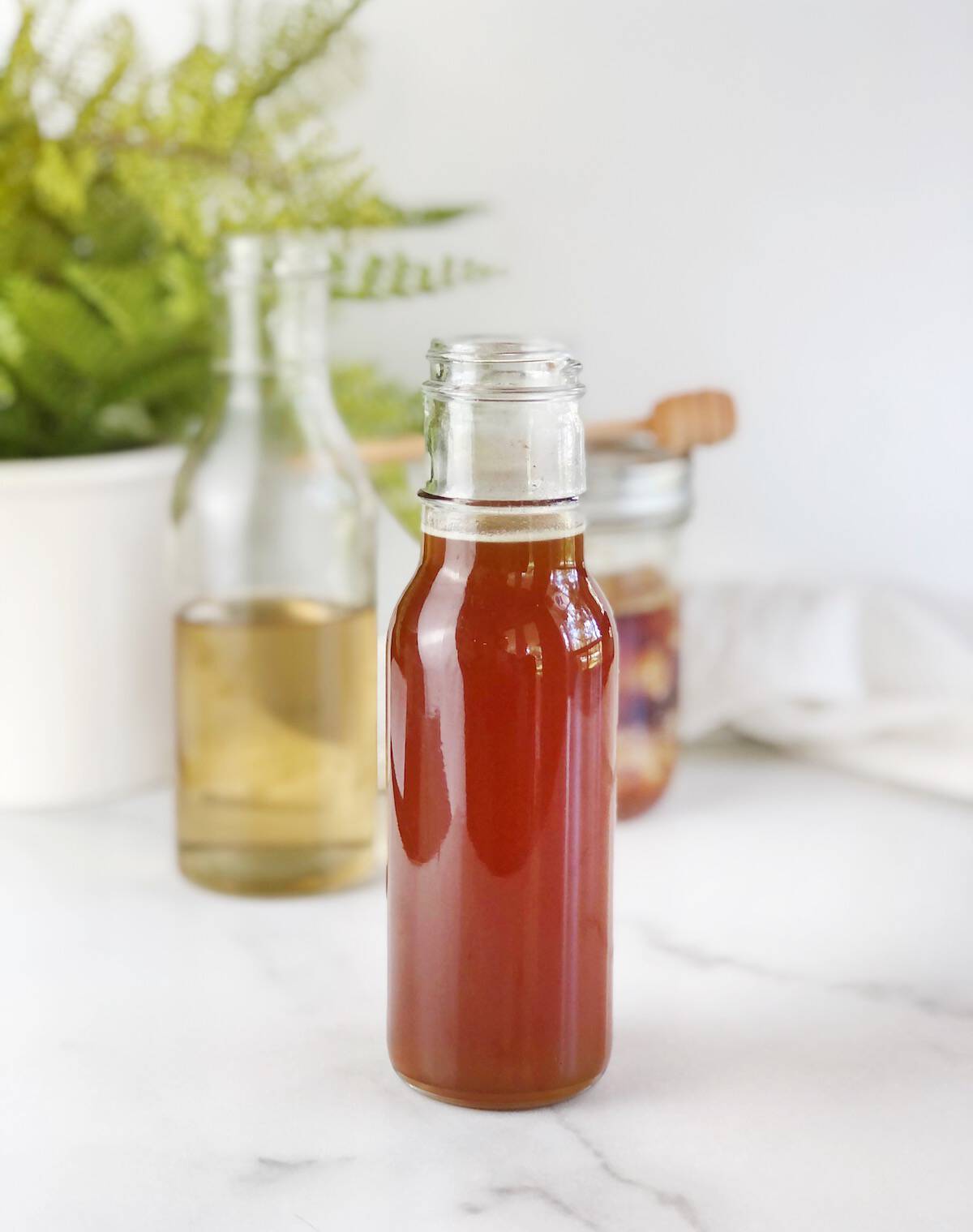 honey simple syrup in containers on a table
