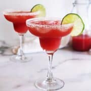 watermelon margarita in glasses with lime garnish