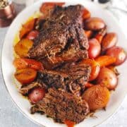 Jewish brisket on plate with carrots and potatoes