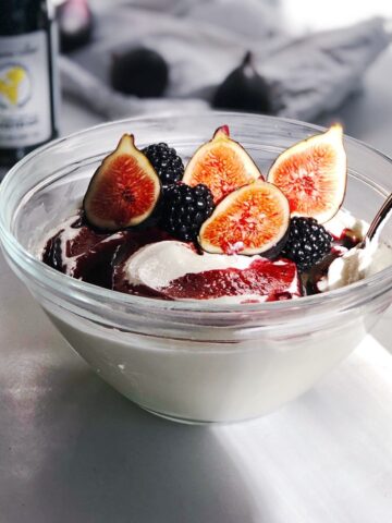 whipped cottage cheese in bowl with figs and honey topping