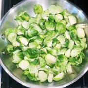 Cleaned and prepared Brussels sprouts in a pan on the stove.