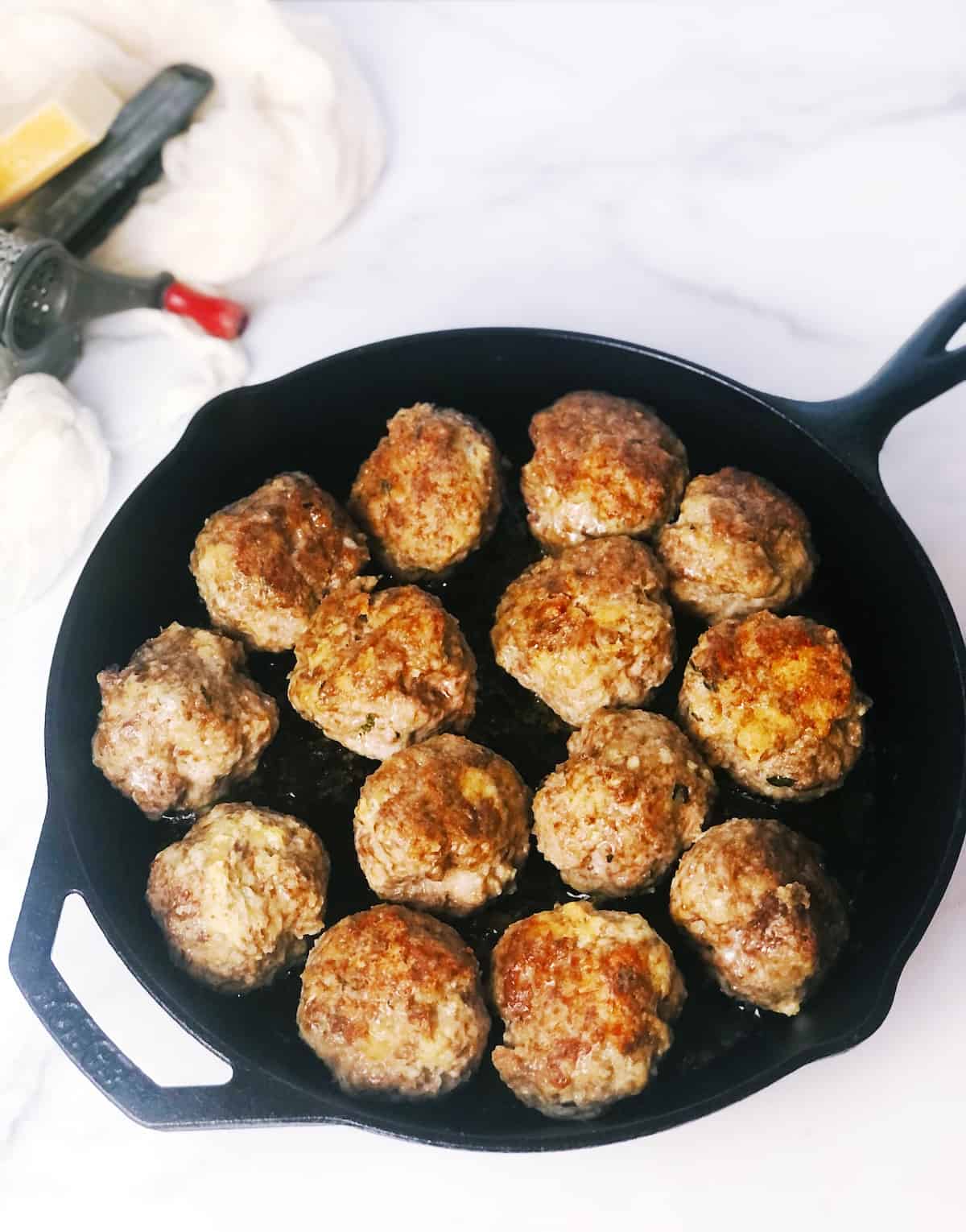 Meatballs in a cast iron skillet.