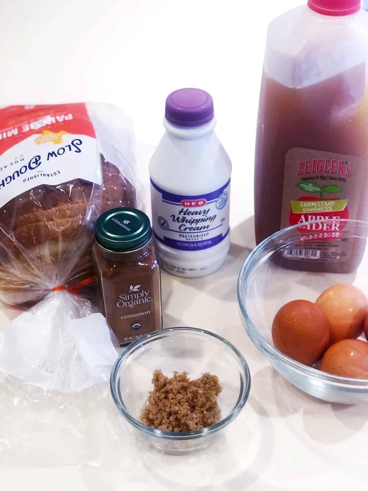 A table with ingredients for apple cider French toast.