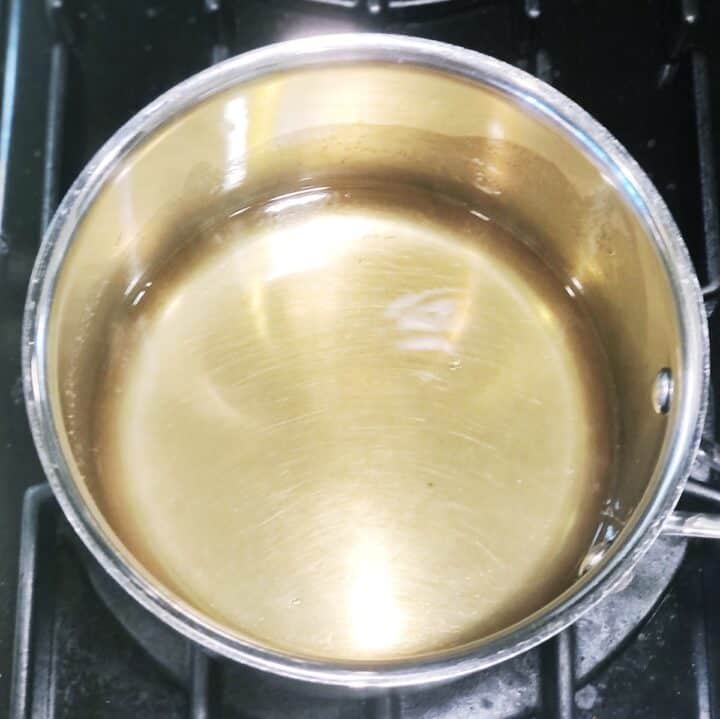 A pot of liquid sitting on a stove top.