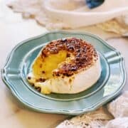 A plate with a piece of cheese on it.