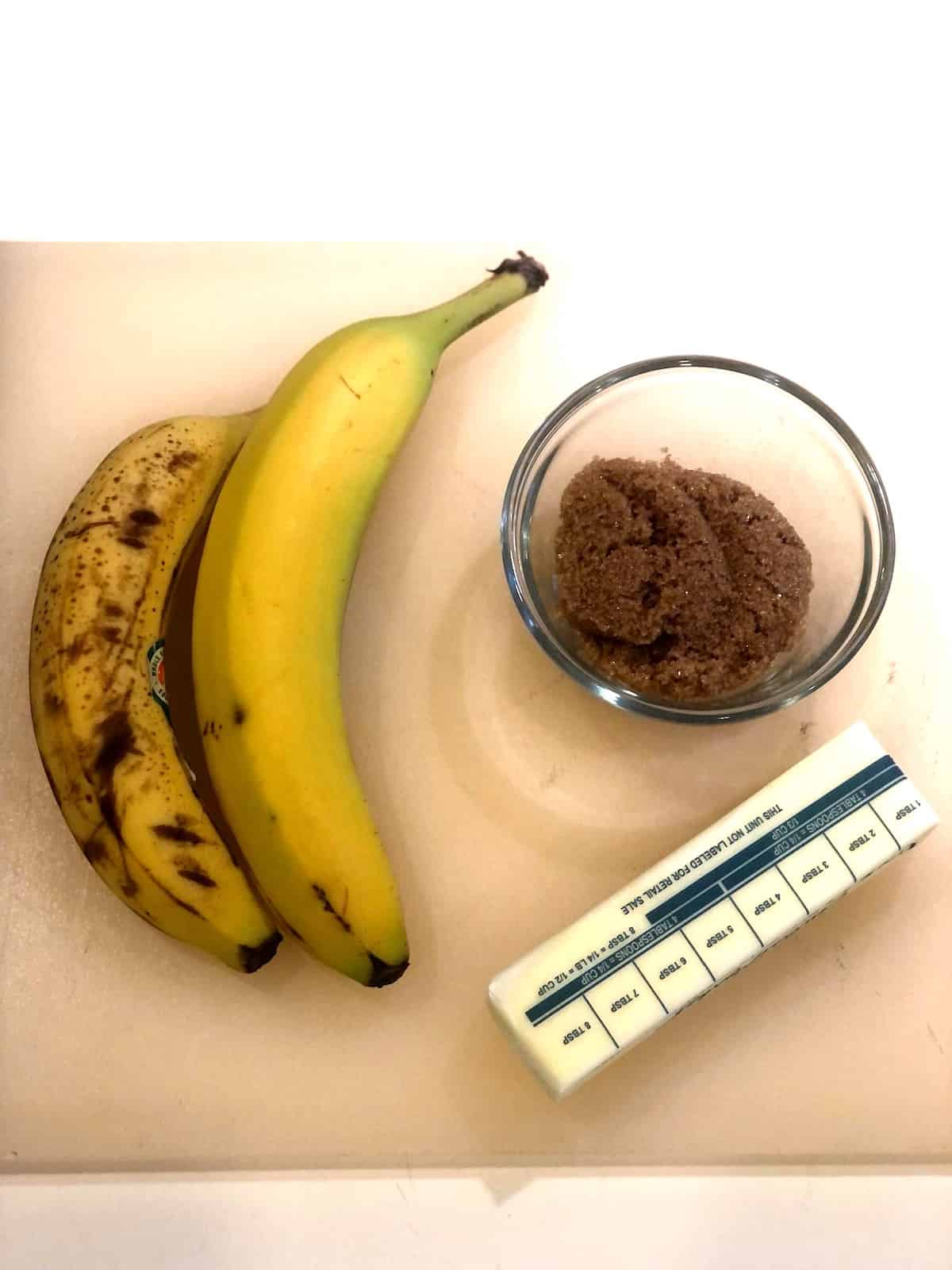 A banana french toast ingredients on a cutting board.