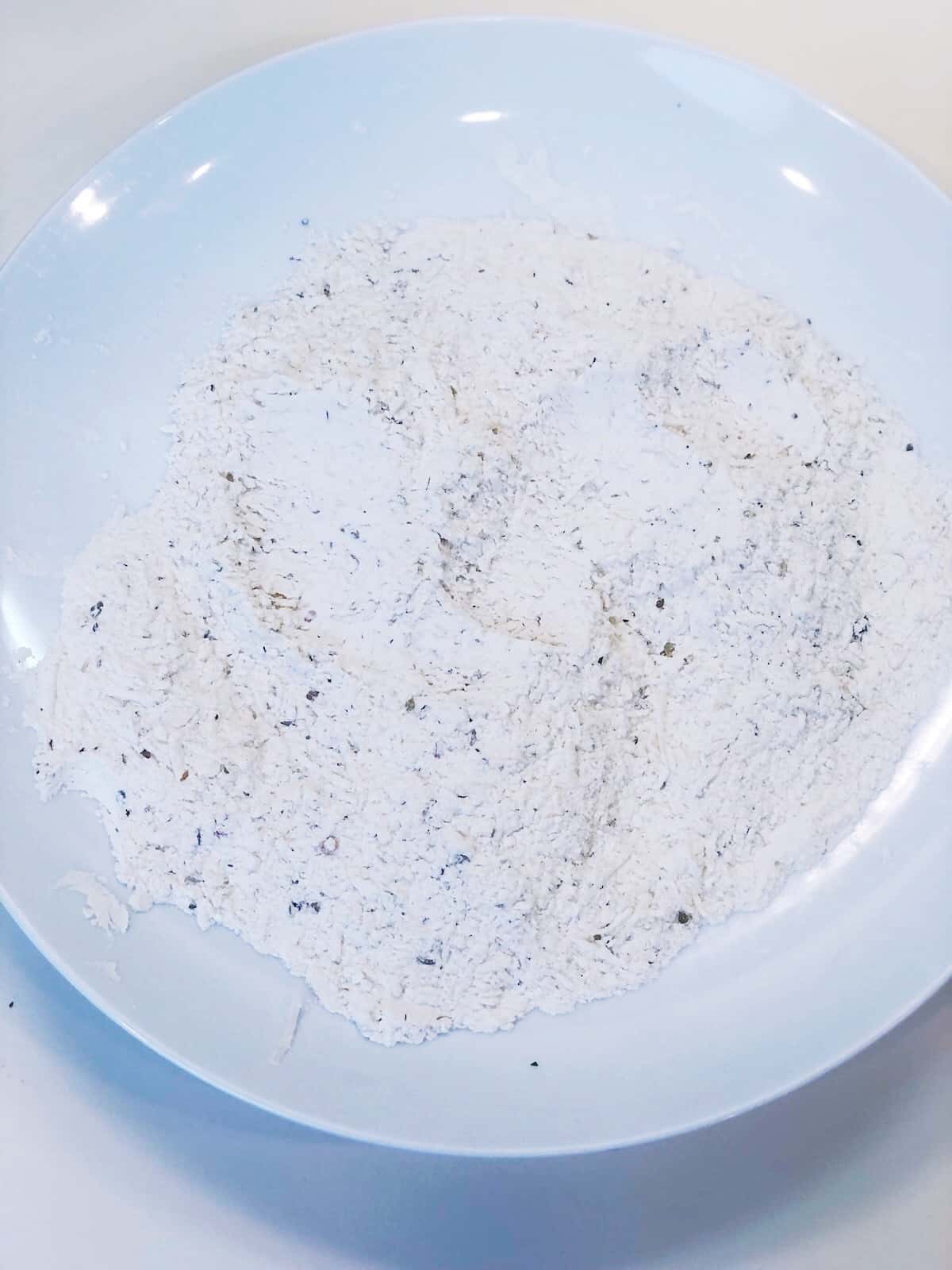 White flour in a bowl on a table.