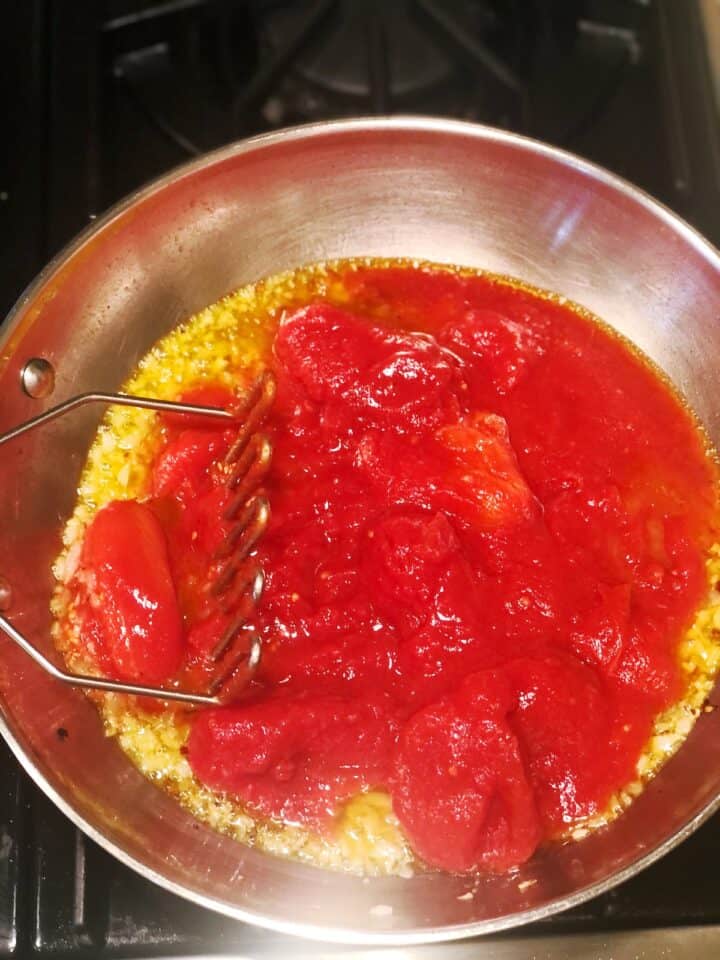 Tomato sauce in a pan with a fork.