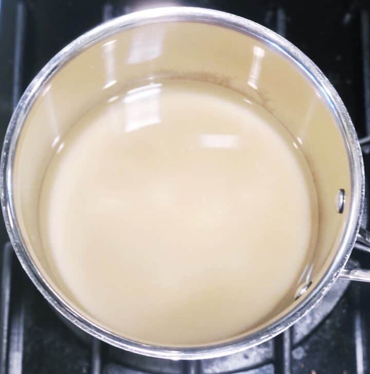 A pot of liquid sitting on top of a stove.