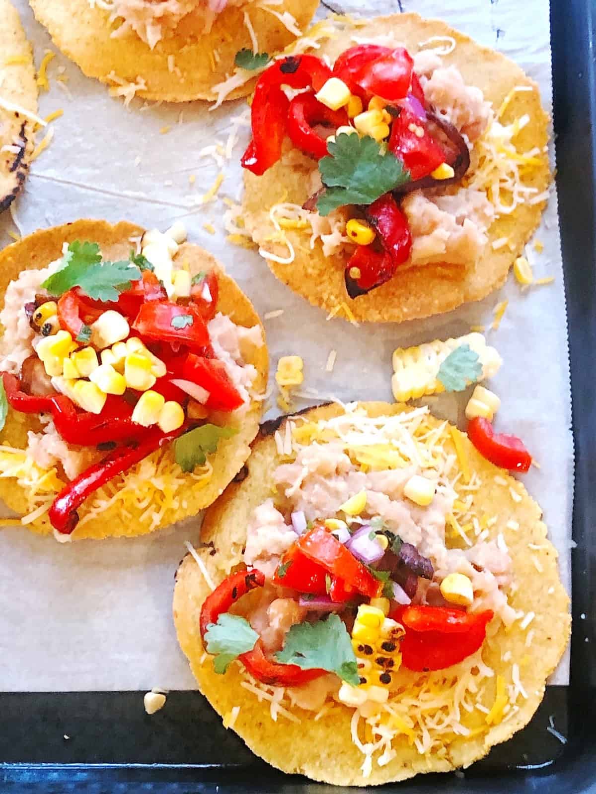 Mexican corn tostadas on a baking sheet.