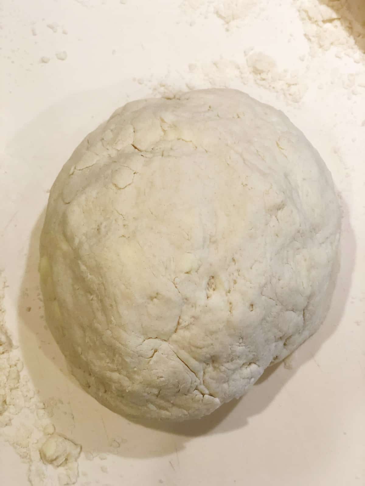 A ball of dough on a white surface.