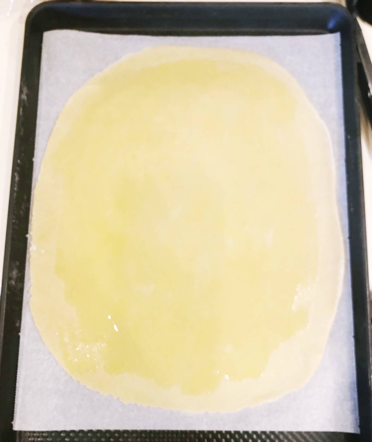 A sheet of pastry dough on a baking sheet.