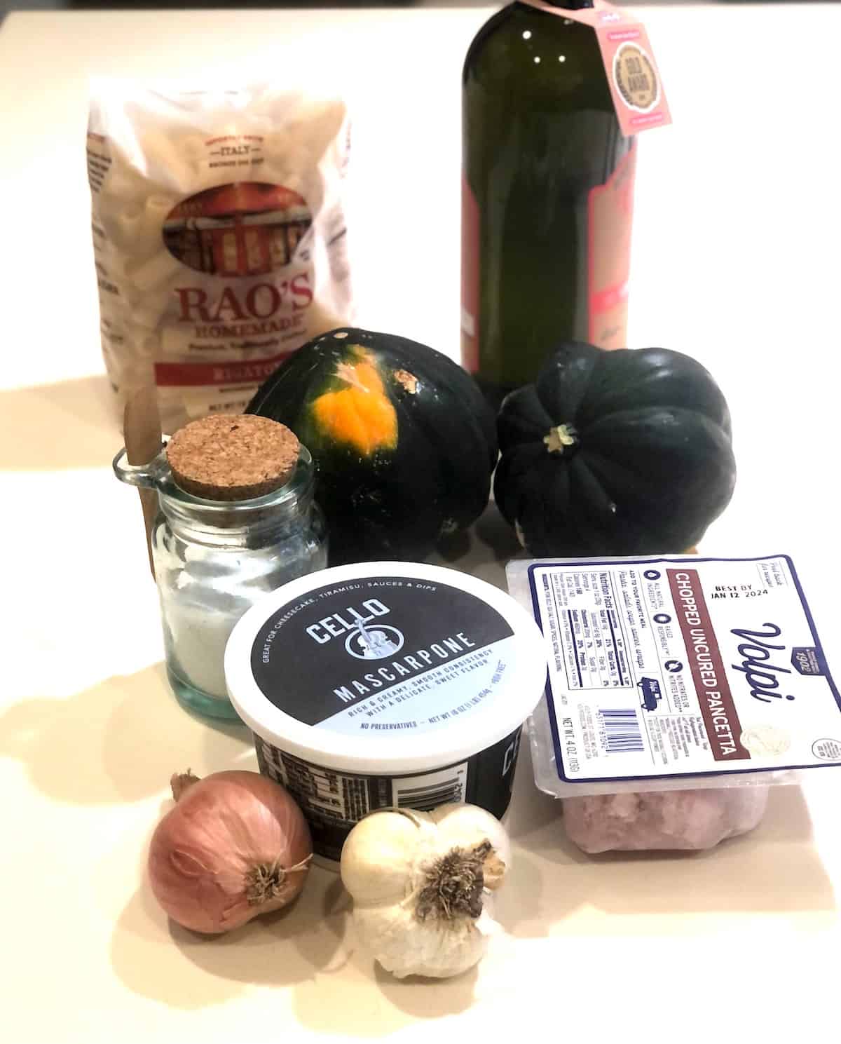 The ingredients for acorn squash pasta are on a table.