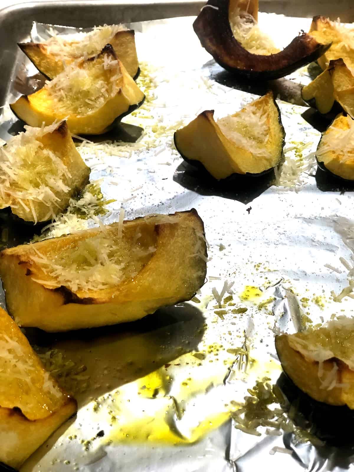Sliced acorn squash on a baking sheet.