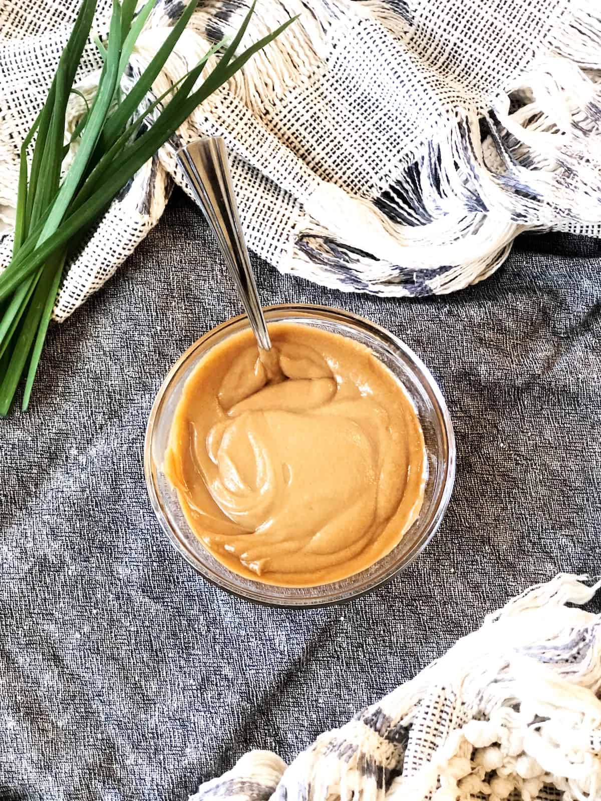 satay sauce in a bowl with a spoon.