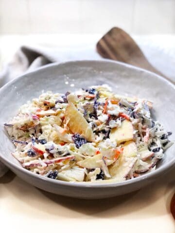 Cranberry Apple Coleslaw in a large bowl on the counter.