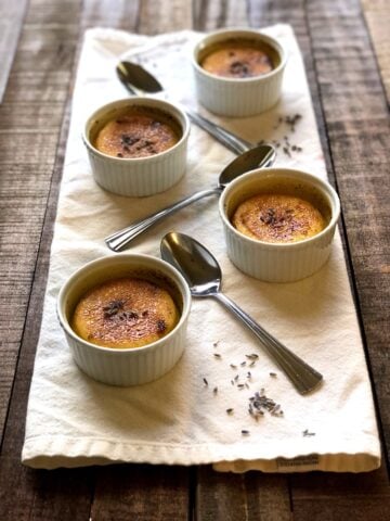 lavender creme brulee on a white napkin on a wood table