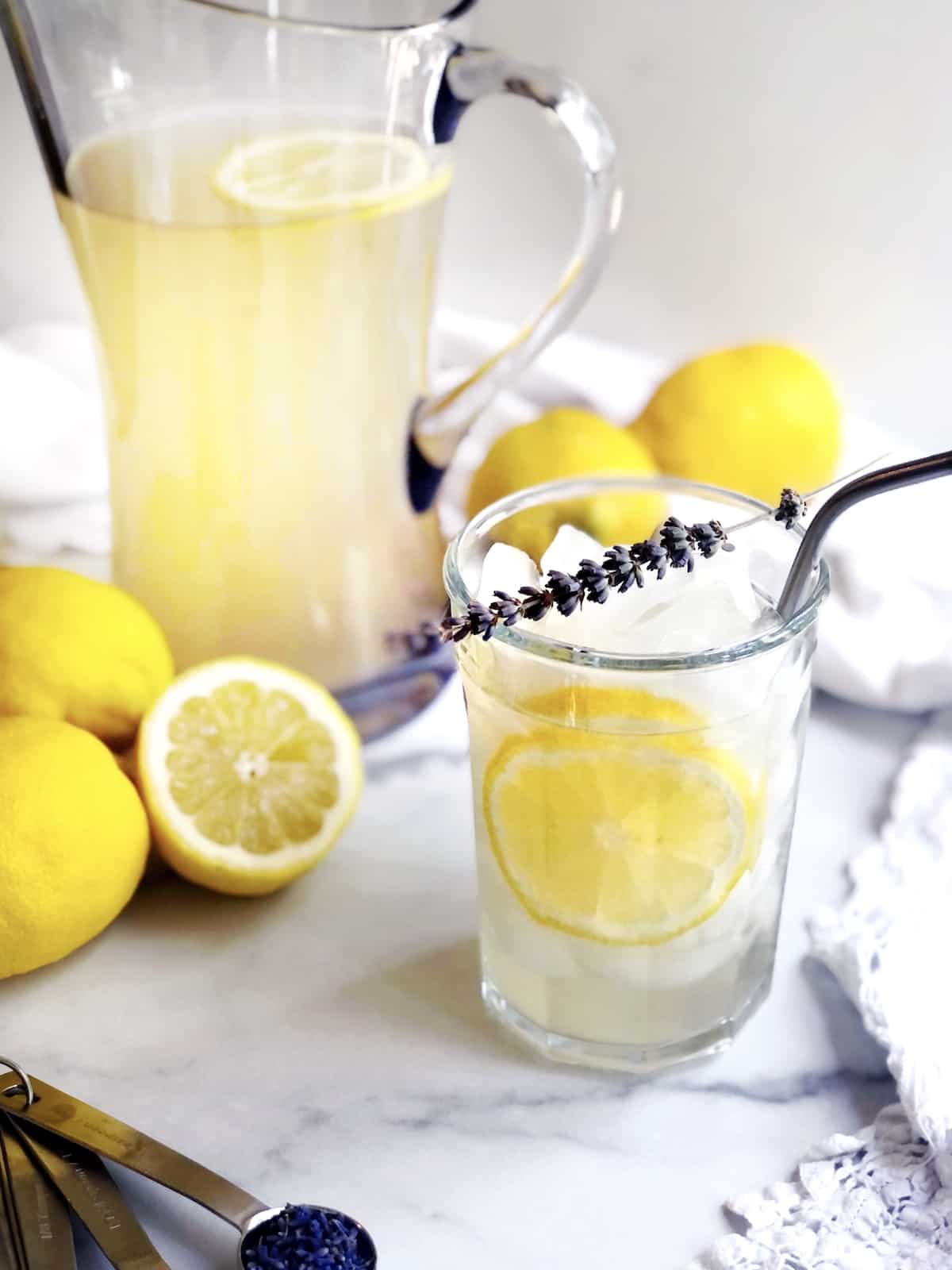 Lavender honey lemonade in a pitcher on the counter.