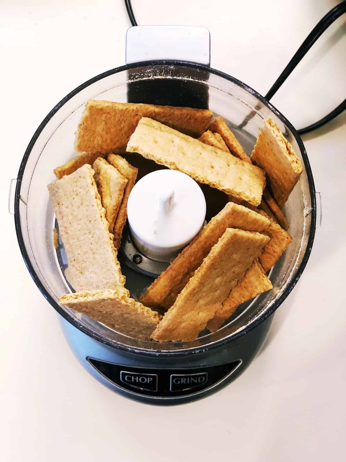 Graham crackers in the food processor for Mini Key Lime Cheesecakes crust.