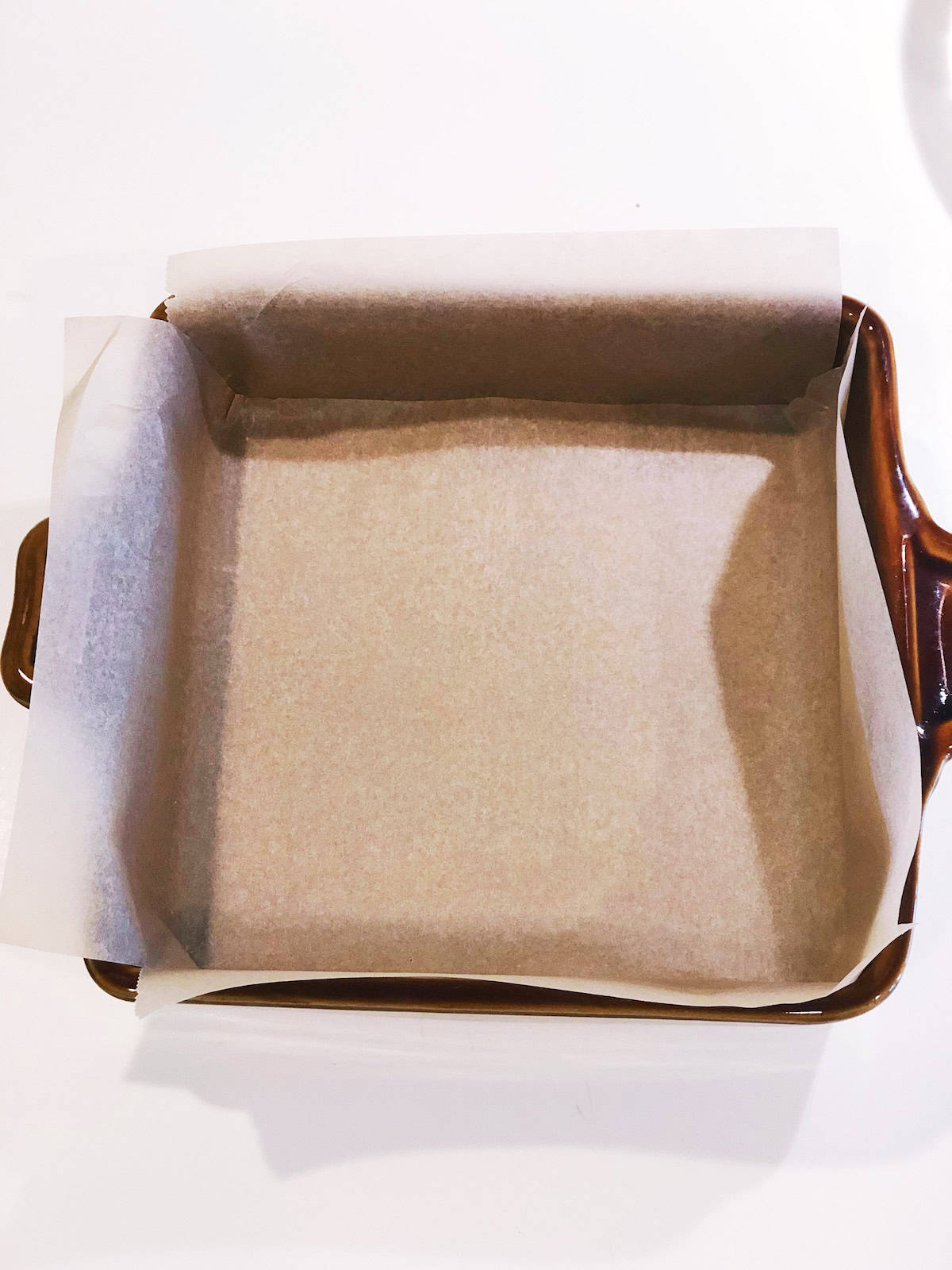 Lining pan with parchment paper.