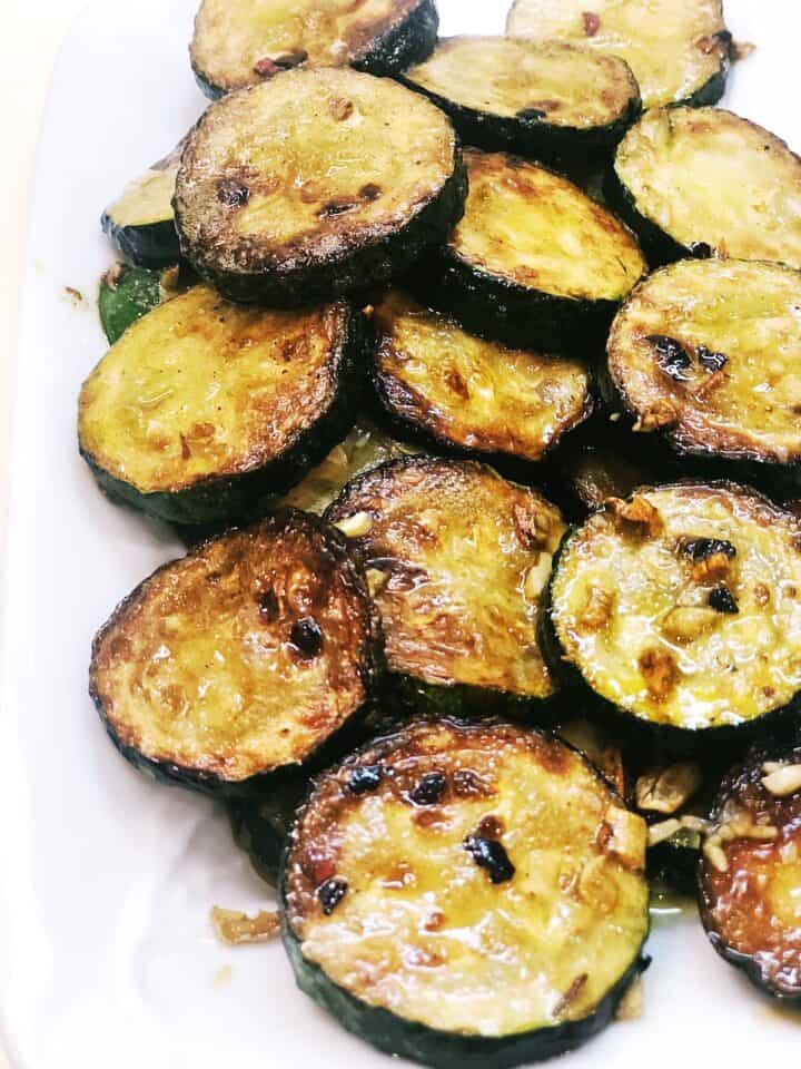 Closeup of the brown butter sauteed zucchini on a plate.