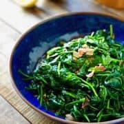 Cooked spinach in a large bowl.