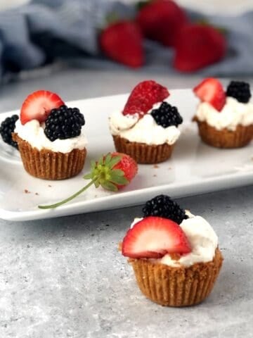 Berries and cream cookie cups assembled on a plate.