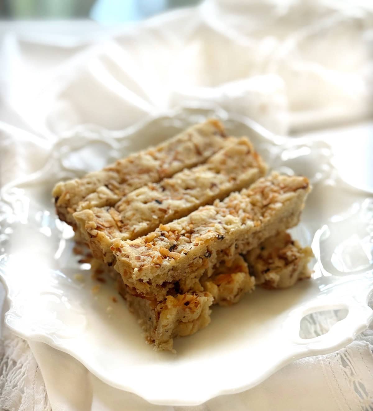 Coconut shortbread bars on a plate.
