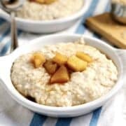 Apple cider oatmeal in a small bowl on the counter.