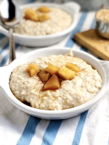 Apple cider oatmeal in a small bowl on the counter.