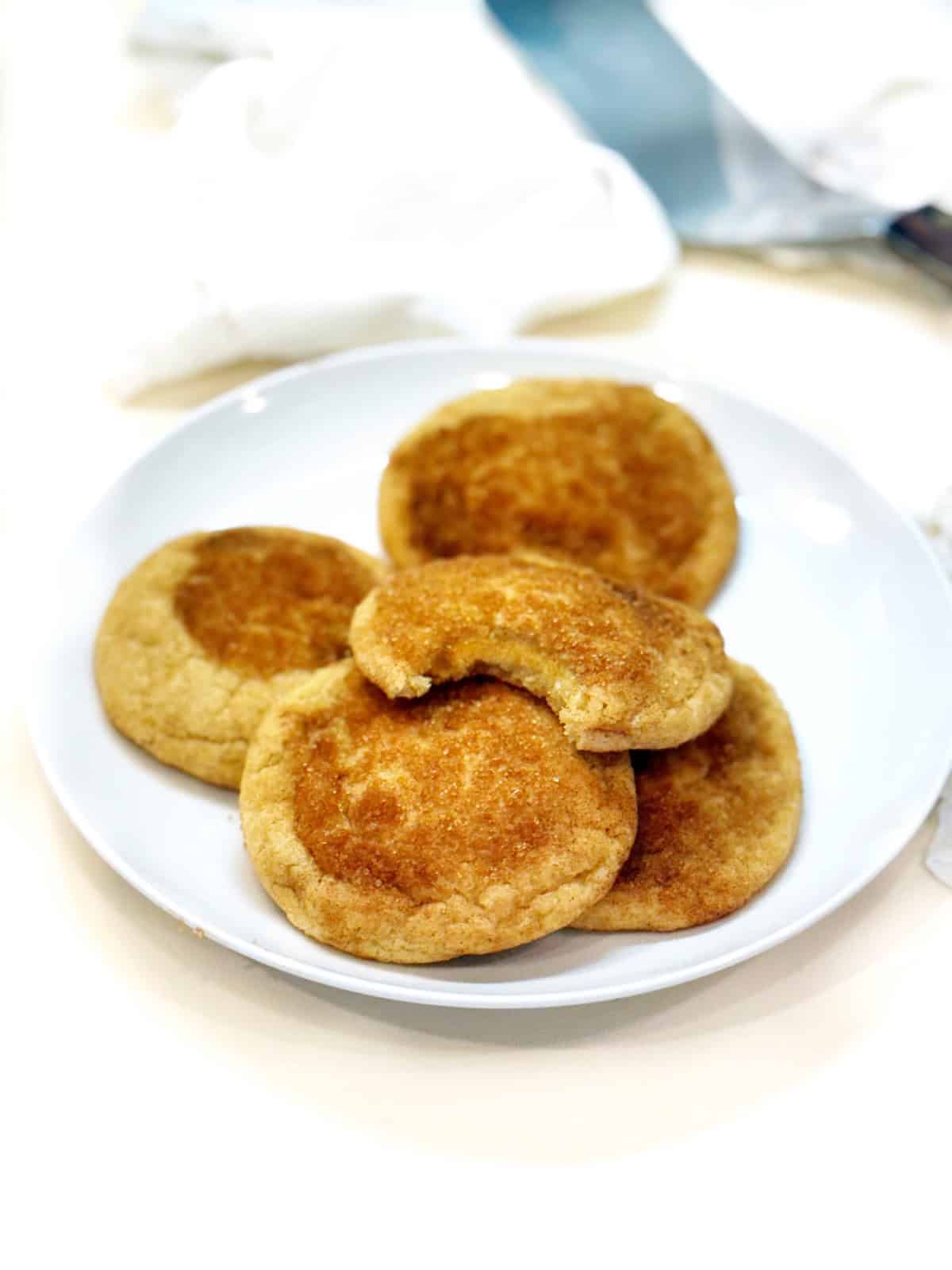 Brown butter snickerdoodle cookies on a plate.